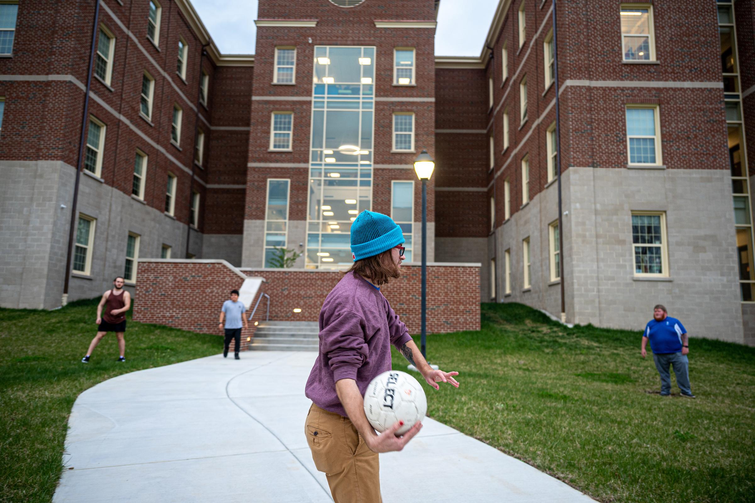 Students playing with a ball outside of Kettering Residence Hall at Berea College.