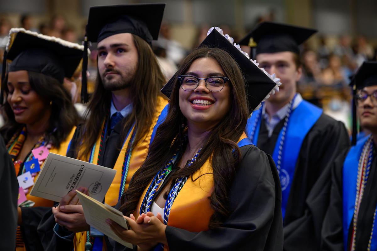 Berea College graduate smiles brightly at the Commencement ceremony.