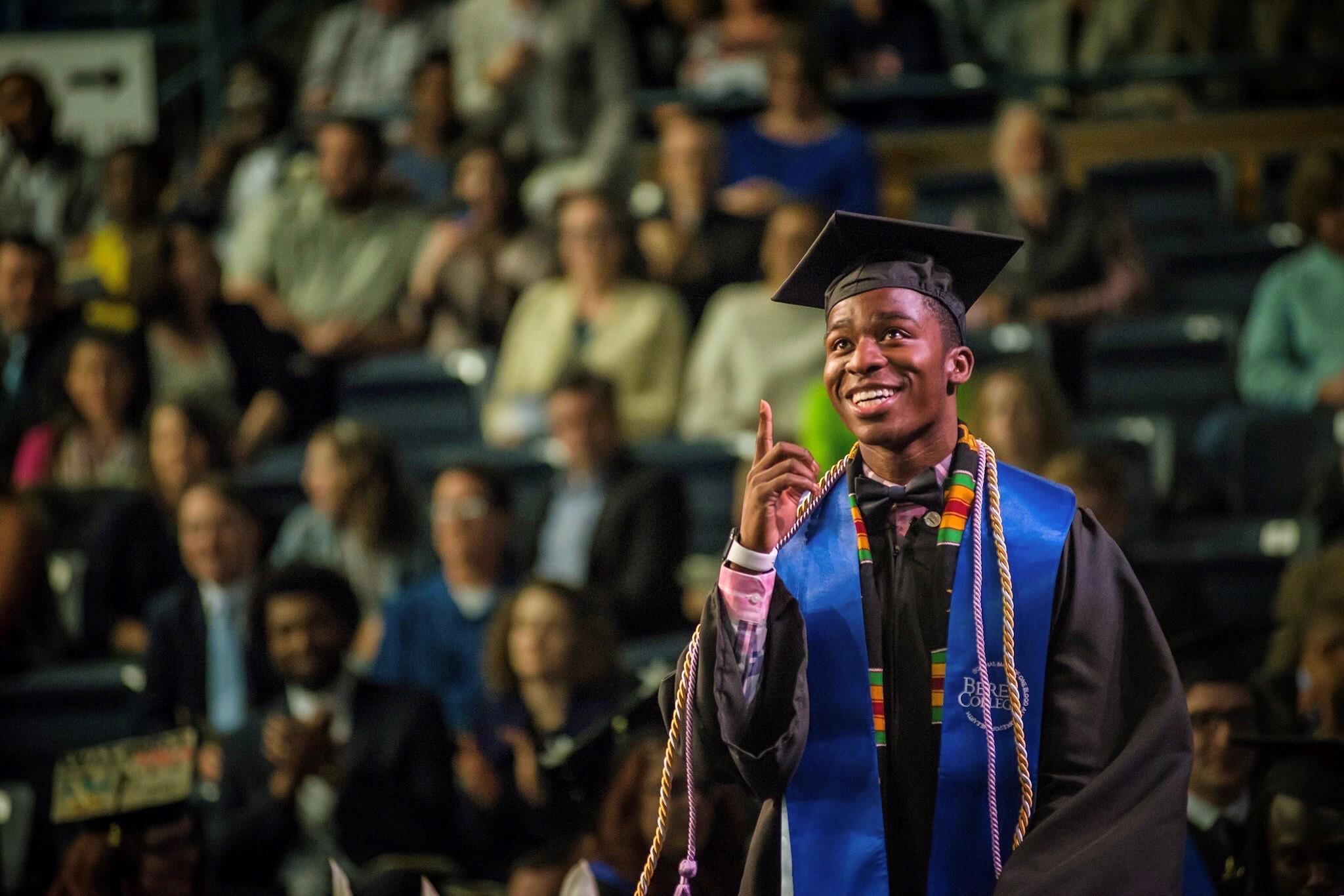 Anthony Myrks-Brewer '17 points to the sky in gratitude as he walks across the stage at graduation.
